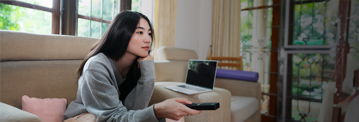 woman sitting on couch watching TV