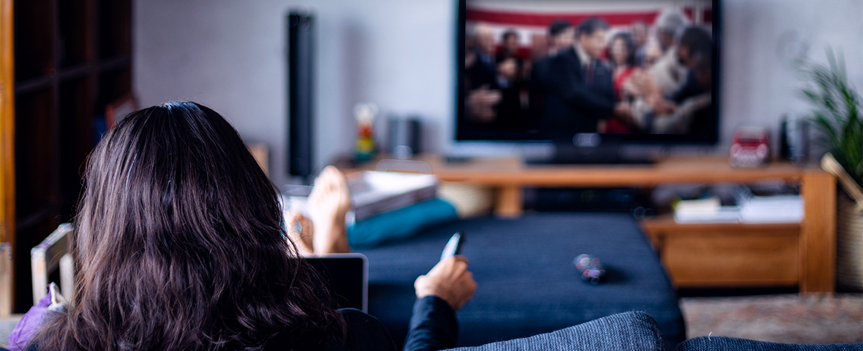 Woman watching political advertising on a television
