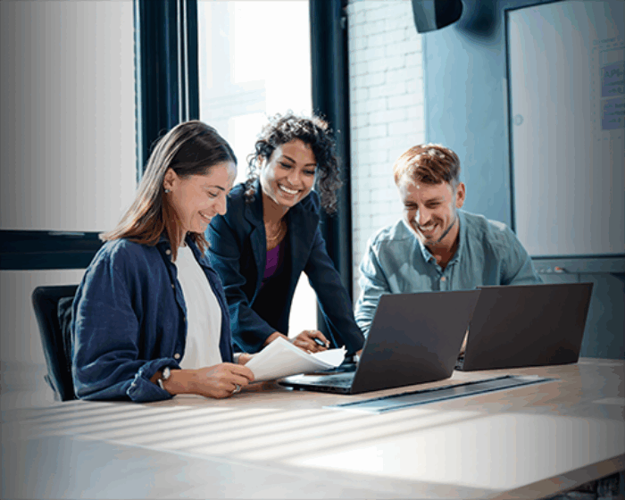 Group of three people working together at a conference table