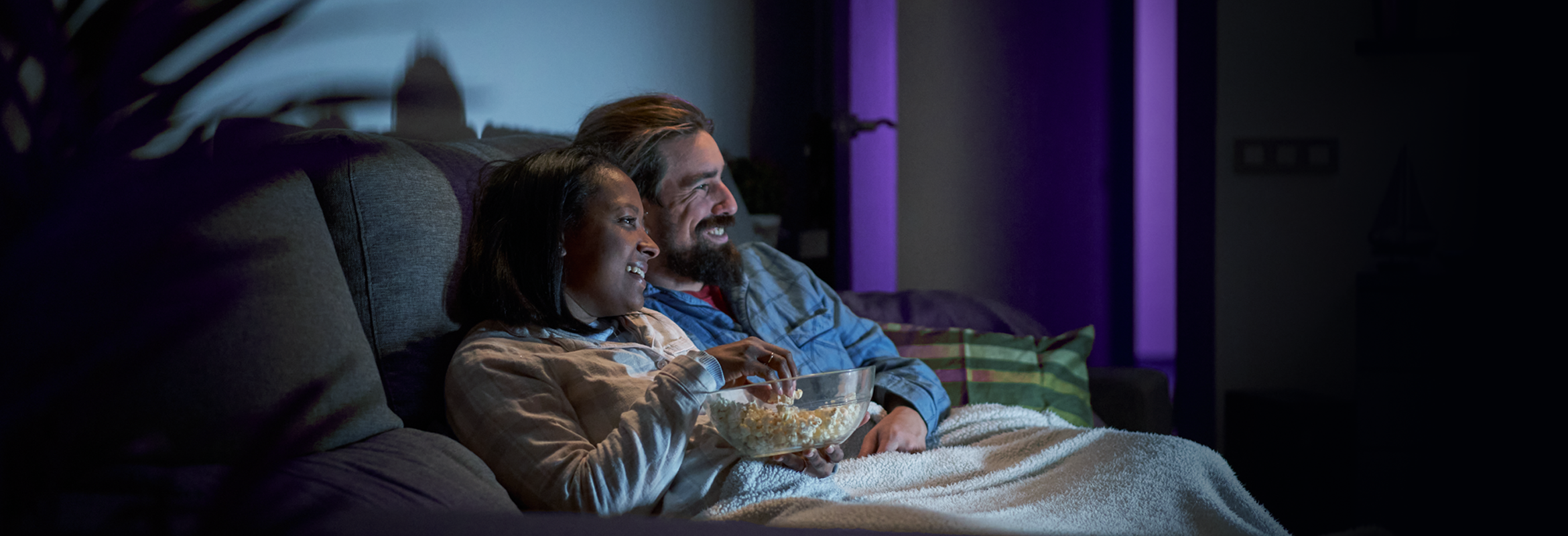 Couple watching TV on the couch in the living room