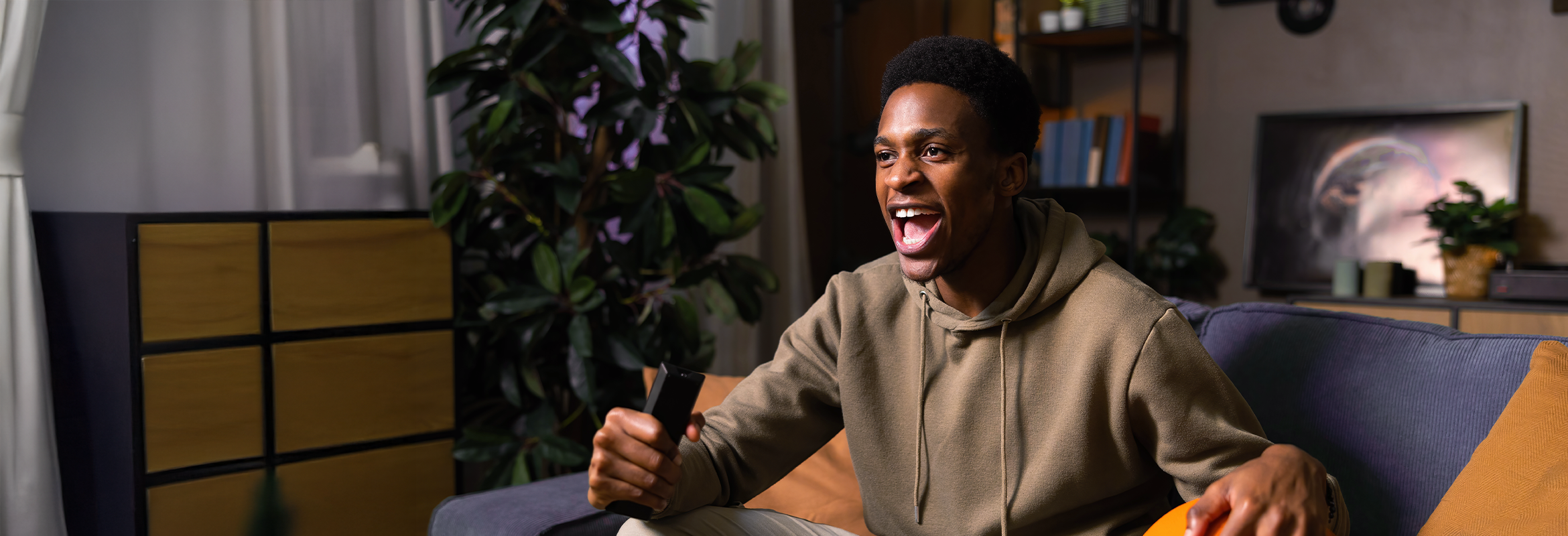 Man watching a live sports game on TV