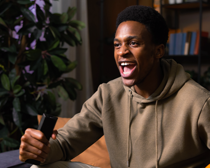 Man watching a live sports game on TV