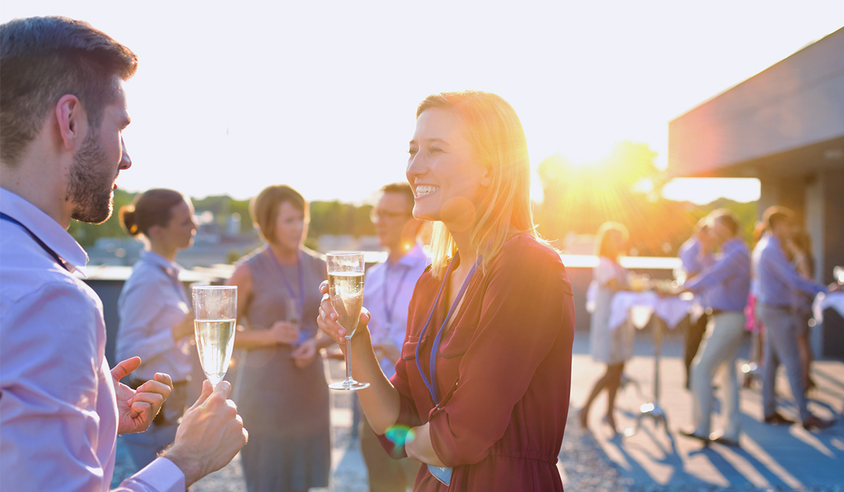 Business professionals chatting at an outdoor networking event