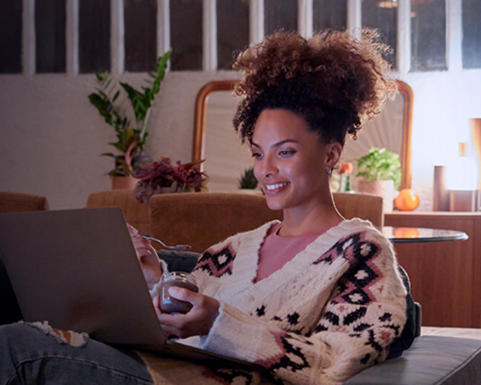 Woman watching a streaming show on a laptop