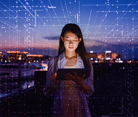 woman working with the power of AI visualized around her as a grid of light